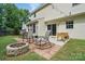 Relaxing backyard with a brick patio, stone fire pit, and comfortable rocking chairs at 8381 Chatsworth Dr, Indian Land, SC 29707