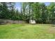 Fenced backyard with a shed, play area, and plenty of space for outdoor activities at 8381 Chatsworth Dr, Indian Land, SC 29707