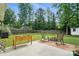 Spacious backyard with a fire pit, patio, fenced perimeter, and lush lawn for outdoor enjoyment at 8381 Chatsworth Dr, Indian Land, SC 29707