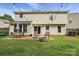 Charming backyard featuring a brick patio, fire pit, and outdoor seating area at 8381 Chatsworth Dr, Indian Land, SC 29707
