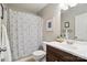 Charming bathroom featuring a vanity with dark wood cabinets and a blue patterned shower curtain at 8381 Chatsworth Dr, Indian Land, SC 29707