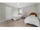 Comfortable bedroom with two twin beds, carpet flooring, and a view of the side yard at 8381 Chatsworth Dr, Indian Land, SC 29707