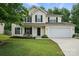 Inviting two-story home features a well-manicured lawn, attached garage, and classic design elements at 8381 Chatsworth Dr, Indian Land, SC 29707