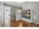 Bright hallway with wood floors, open doorway, and a storage shelf with cube storage at 8381 Chatsworth Dr, Indian Land, SC 29707