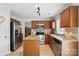 Updated kitchen with stainless steel appliances, granite counters, and tile flooring at 8381 Chatsworth Dr, Indian Land, SC 29707