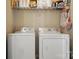 Functional laundry room equipped with a washer, dryer, and wire rack shelf storage at 8381 Chatsworth Dr, Indian Land, SC 29707