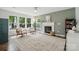 Bright living room featuring a fireplace, neutral decor, and hardwood flooring at 8381 Chatsworth Dr, Indian Land, SC 29707
