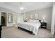 Spacious main bedroom with tray ceilings, two windows and neutral color palette at 8381 Chatsworth Dr, Indian Land, SC 29707