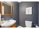 Stylish powder room with wood vanity, neutral paint and updated fixtures at 8381 Chatsworth Dr, Indian Land, SC 29707
