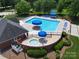 Community pool with hot tub, lounge chairs, and umbrellas at 8744 Barrister Way, Charlotte, NC 28216