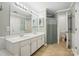 Bright bathroom featuring a double sink vanity, tiled floor, and a shower-tub combo at 8744 Barrister Way, Charlotte, NC 28216