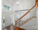 Bright foyer with hardwood floors, chandelier, and stairway at 8744 Barrister Way, Charlotte, NC 28216