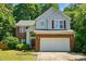 Charming two-story home featuring a brick and vinyl exterior, attached two-car garage, and well-manicured landscaping at 8744 Barrister Way, Charlotte, NC 28216