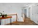 Bright hallway with wood floors, white trim, and a view of the staircase at 8744 Barrister Way, Charlotte, NC 28216