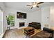 Inviting living room with hardwood floors, fireplace, large windows, and comfortable seating at 8744 Barrister Way, Charlotte, NC 28216