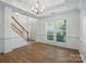 Bright living room with wood floors, stairs, and lots of natural light at 8744 Barrister Way, Charlotte, NC 28216