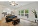 Open-concept living room featuring hardwood floors, large windows, and comfortable seating at 8744 Barrister Way, Charlotte, NC 28216