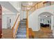 Staircase with wood railing and decorative risers lead to the second level of the home at 8744 Barrister Way, Charlotte, NC 28216