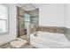 Bathroom boasts a separate tiled shower and luxurious soaking tub at 8916 Inverness Bay Rd, Charlotte, NC 28278