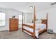Bedroom featuring wood frame bed, dresser, and lots of natural light at 8916 Inverness Bay Rd, Charlotte, NC 28278