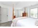 Bright bedroom featuring a wood frame bed, neutral walls, and carpet flooring at 8916 Inverness Bay Rd, Charlotte, NC 28278