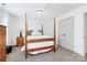 Cozy bedroom featuring a wooden four-poster bed, soft lighting, and neutral decor at 8916 Inverness Bay Rd, Charlotte, NC 28278