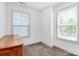 Bright bedroom with two windows, plush carpet, and a wooden dresser at 8916 Inverness Bay Rd, Charlotte, NC 28278