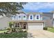 Charming two-story home featuring a well-manicured lawn and an attached two-car garage at 8916 Inverness Bay Rd, Charlotte, NC 28278