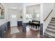 Elegant foyer with hardwood floors, staircase, wainscoting, and access to the dining area at 8916 Inverness Bay Rd, Charlotte, NC 28278