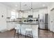 Well-lit kitchen with stainless steel appliances, granite countertops, and a stylish breakfast bar area with seating at 8916 Inverness Bay Rd, Charlotte, NC 28278