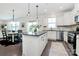 Kitchen with granite island flowing into dining area and stainless appliances, with natural light at 8916 Inverness Bay Rd, Charlotte, NC 28278