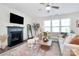 Comfortable living room with a fireplace, ceiling fan, and bright natural lighting at 8916 Inverness Bay Rd, Charlotte, NC 28278