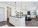 Kitchen island with view to the living room and dining area, featuring modern accents at 8916 Inverness Bay Rd, Charlotte, NC 28278