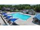 Amazing aerial view of the neighborhood pool with many umbrellas for shade at 8916 Inverness Bay Rd, Charlotte, NC 28278