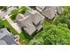 Birds eye view of home with landscaped backyard, patio, mature trees and beautiful rooflines at 9034 Kensington Forest Dr, Harrisburg, NC 28075
