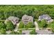 Beautiful aerial view of a well-maintained suburban home surrounded by lush greenery and manicured lawns at 9034 Kensington Forest Dr, Harrisburg, NC 28075