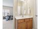 Bathroom with vanity, white walls and cabinets, and a view of an adjacent room at 9034 Kensington Forest Dr, Harrisburg, NC 28075