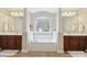 This bathroom offers double sinks, a garden tub, and tile floors at 9034 Kensington Forest Dr, Harrisburg, NC 28075