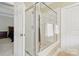 This bathroom offers a glass enclosed shower and a door to the bedroom at 9034 Kensington Forest Dr, Harrisburg, NC 28075
