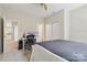 Bedroom with gray comforter, carpet, ceiling fan, and built in desk at 9034 Kensington Forest Dr, Harrisburg, NC 28075