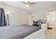 Well-lit bedroom with a ceiling fan and desk next to an adjacent room at 9034 Kensington Forest Dr, Harrisburg, NC 28075