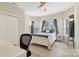 Cozy bedroom featuring a ceiling fan, ample natural light, and neutral decor at 9034 Kensington Forest Dr, Harrisburg, NC 28075