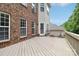 Spacious wood deck is perfect for outdoor entertaining with its brick and vinyl siding exterior view at 9034 Kensington Forest Dr, Harrisburg, NC 28075