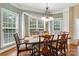 Elegant dining room featuring hardwood floors, large windows, and a decorative light fixture at 9034 Kensington Forest Dr, Harrisburg, NC 28075