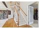 This foyer features a staircase, wood floors, and multiple entryways at 9034 Kensington Forest Dr, Harrisburg, NC 28075