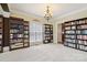 This library offers built-in shelving, a window, and neutral colored walls at 9034 Kensington Forest Dr, Harrisburg, NC 28075