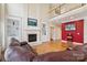 Cozy living room features a fireplace, built-in shelving, hardwood floors, and an open layout at 9034 Kensington Forest Dr, Harrisburg, NC 28075