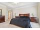 This main bedroom offers a tray ceiling, carpet floors, and neutral colored walls at 9034 Kensington Forest Dr, Harrisburg, NC 28075