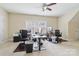 Functional home office with two desks, comfortable chairs, and natural light at 9034 Kensington Forest Dr, Harrisburg, NC 28075