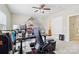 Bright and spacious home office with dual monitors and a comfortable chair at 9034 Kensington Forest Dr, Harrisburg, NC 28075